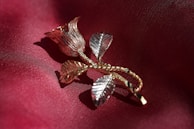 Artistic black and rose gold accents on clothing details, highlighting craftsmanship