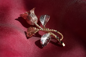 Artistic black and rose gold accents on clothing details, highlighting craftsmanship