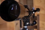 A close up of a telescope pointing to space