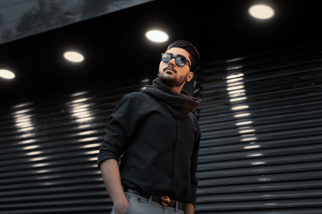 man in black jacket and black sunglasses standing, Photo by Mahdi Bafande