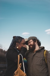 man and woman kissing during daytime