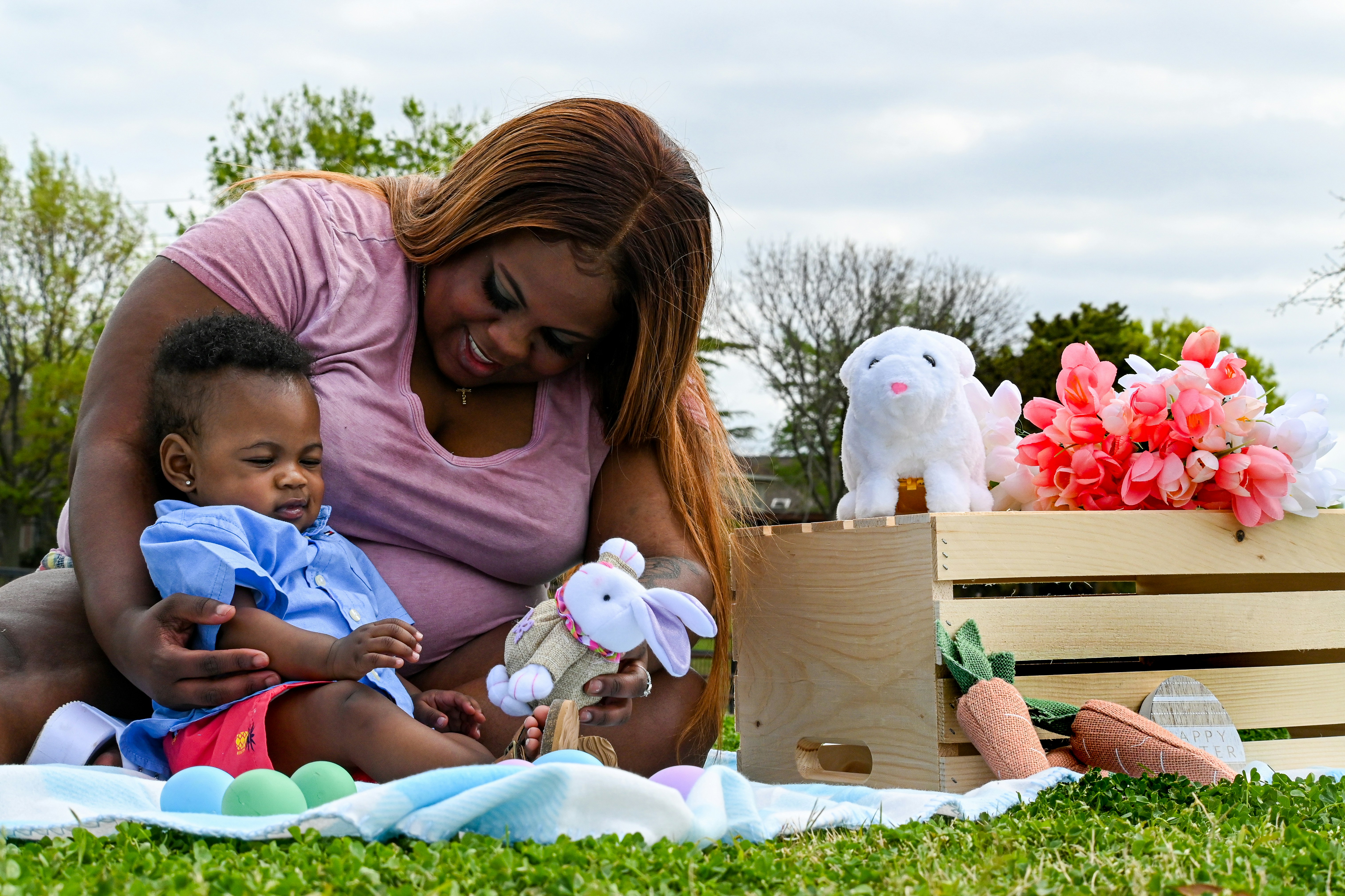 woman in pink shirt sitting beside girl in pink shirt