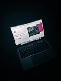 macbook pro on black table