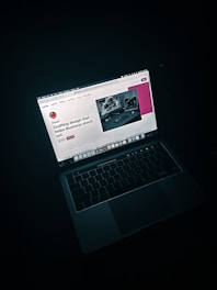 macbook pro on black table