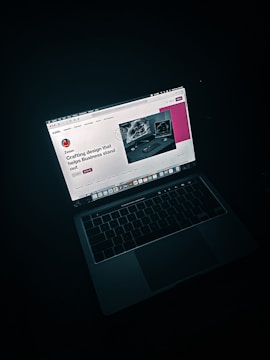 macbook pro on black table