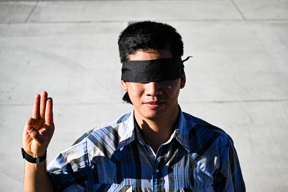 man in blue and white plaid button up shirt wearing black sunglasses