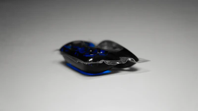 Close-up of hands pouring a vibrant liquid detergent into a washing machine.