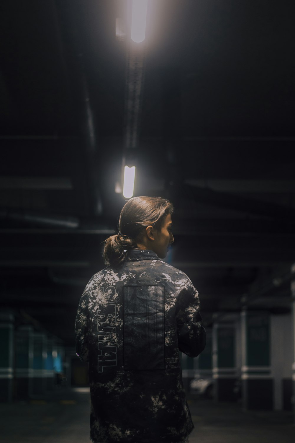 woman in black and white floral shirt standing