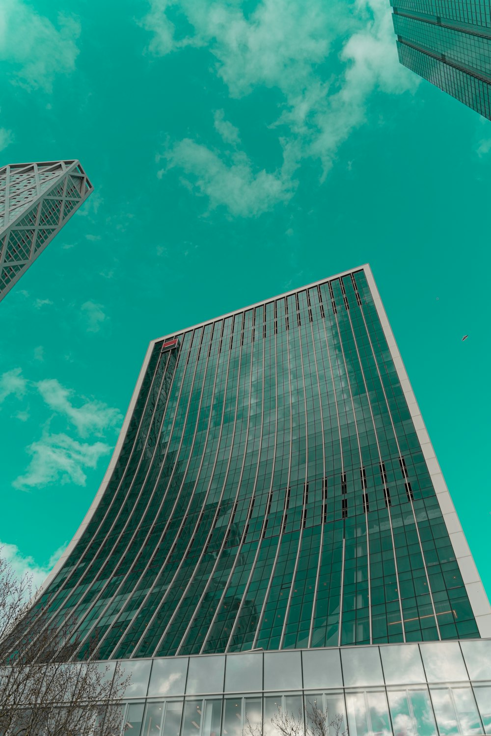 blue and white glass building under blue sky during daytime