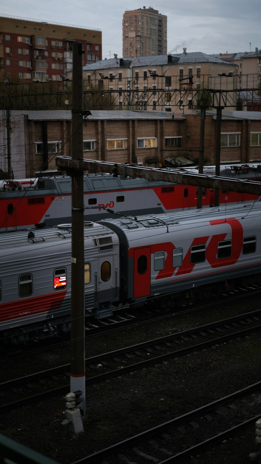 red and white train on rail tracks during daytime