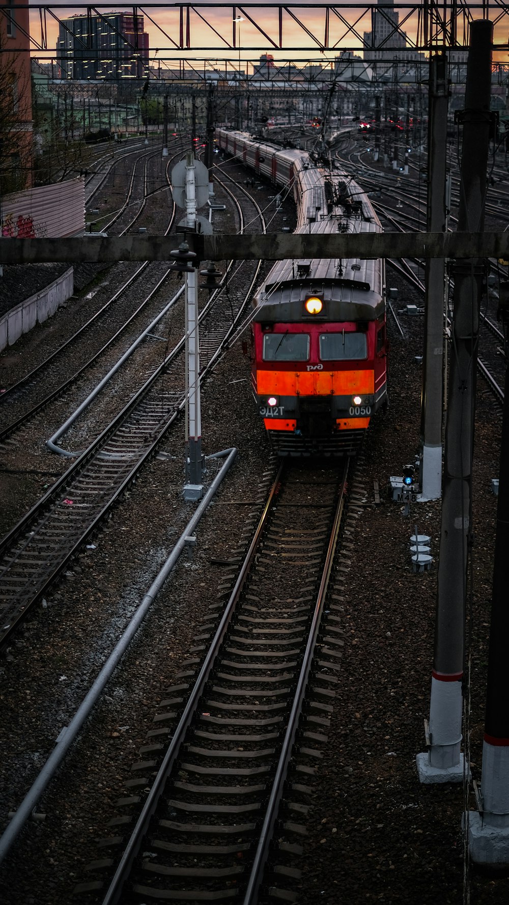 orange and black train on rail tracks