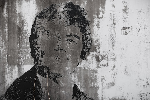 A candid portrait painted on a textured wall, reflecting individuality and authenticity.