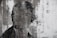 A black and white edgy portrait of a man with a graffiti background.