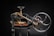 A vintage mechanical device composed of mainly black metal with some brass elements. The machine features a large hand wheel, connected via rods and levers, and includes a cutting blade at the base. Intricate components and gears add to the complexity of the machinery.