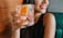 A smiling customer holding a beautifully etched glassware.