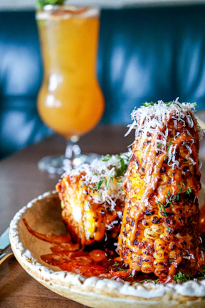 Golden corn on the cob brushed with butter and sprinkled with spices.