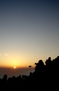 Members participating in a birdwatching event at sunrise.
