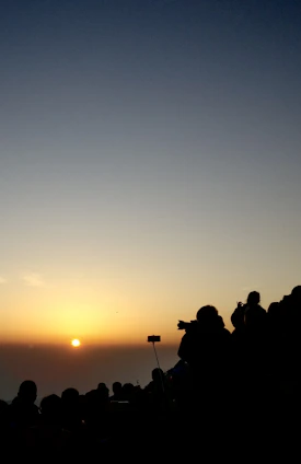 A group of travelers capturing the sunrise over the lush hills of Bandarban, cameras poised and smiles wide.