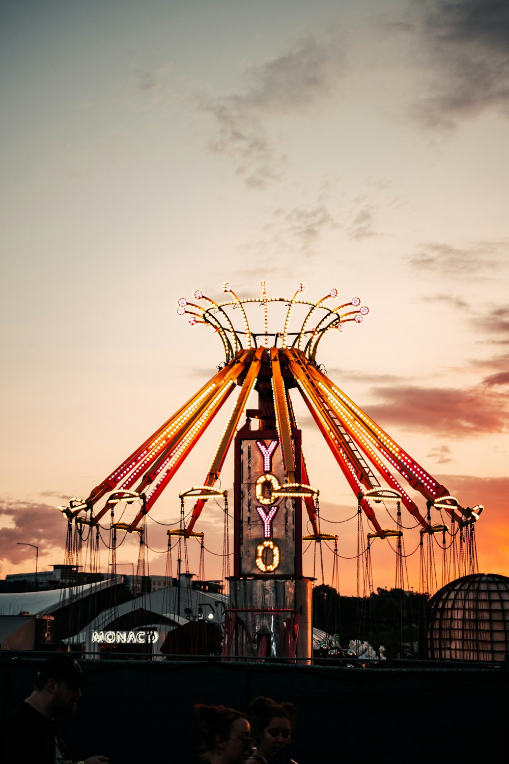 people riding on yellow and red roller coaster during daytime