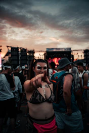 Photo of David Stringer at a local music festival, holding a camera with a backdrop of a lively crowd at sunset.