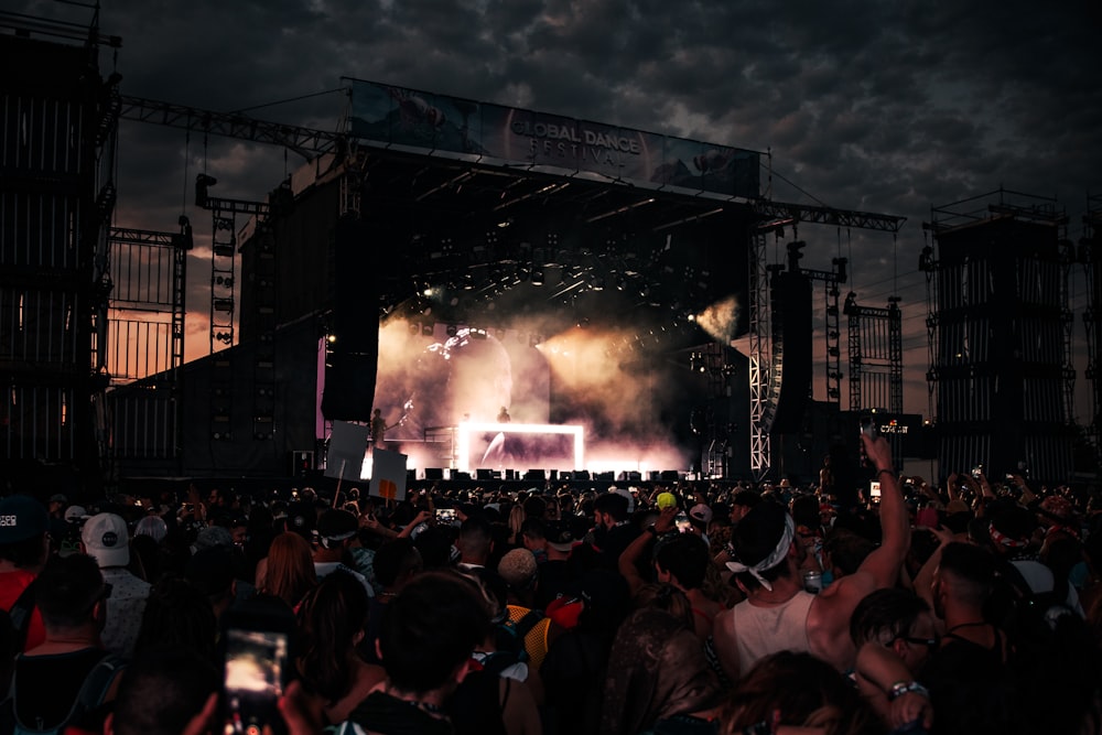 crowd of people watching concert during night time