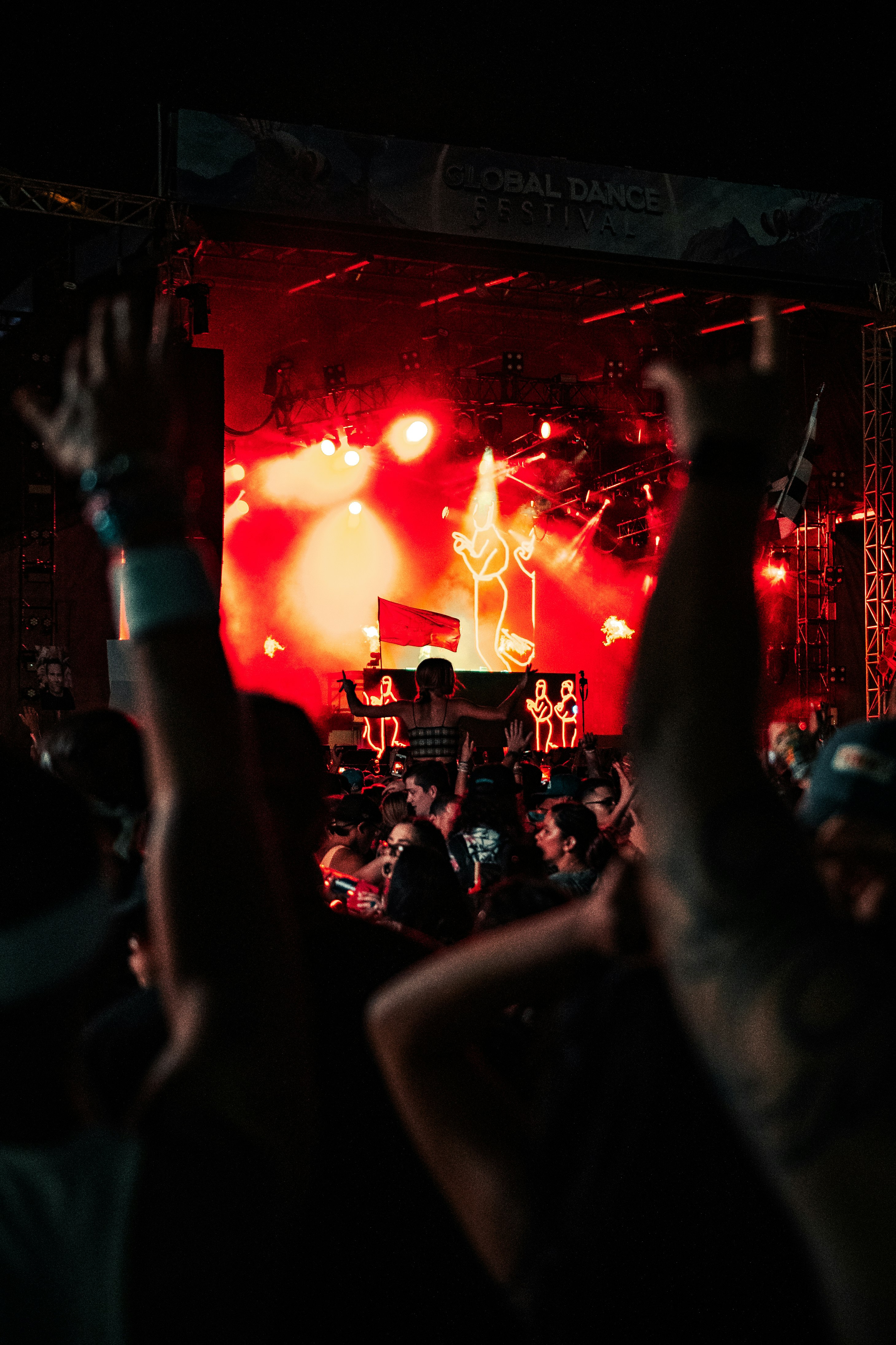 people raising their hands in front of stage