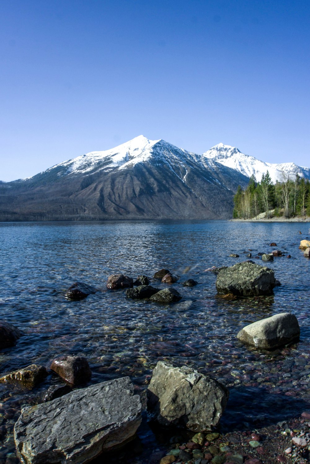 rocky mountain near body of water during daytime