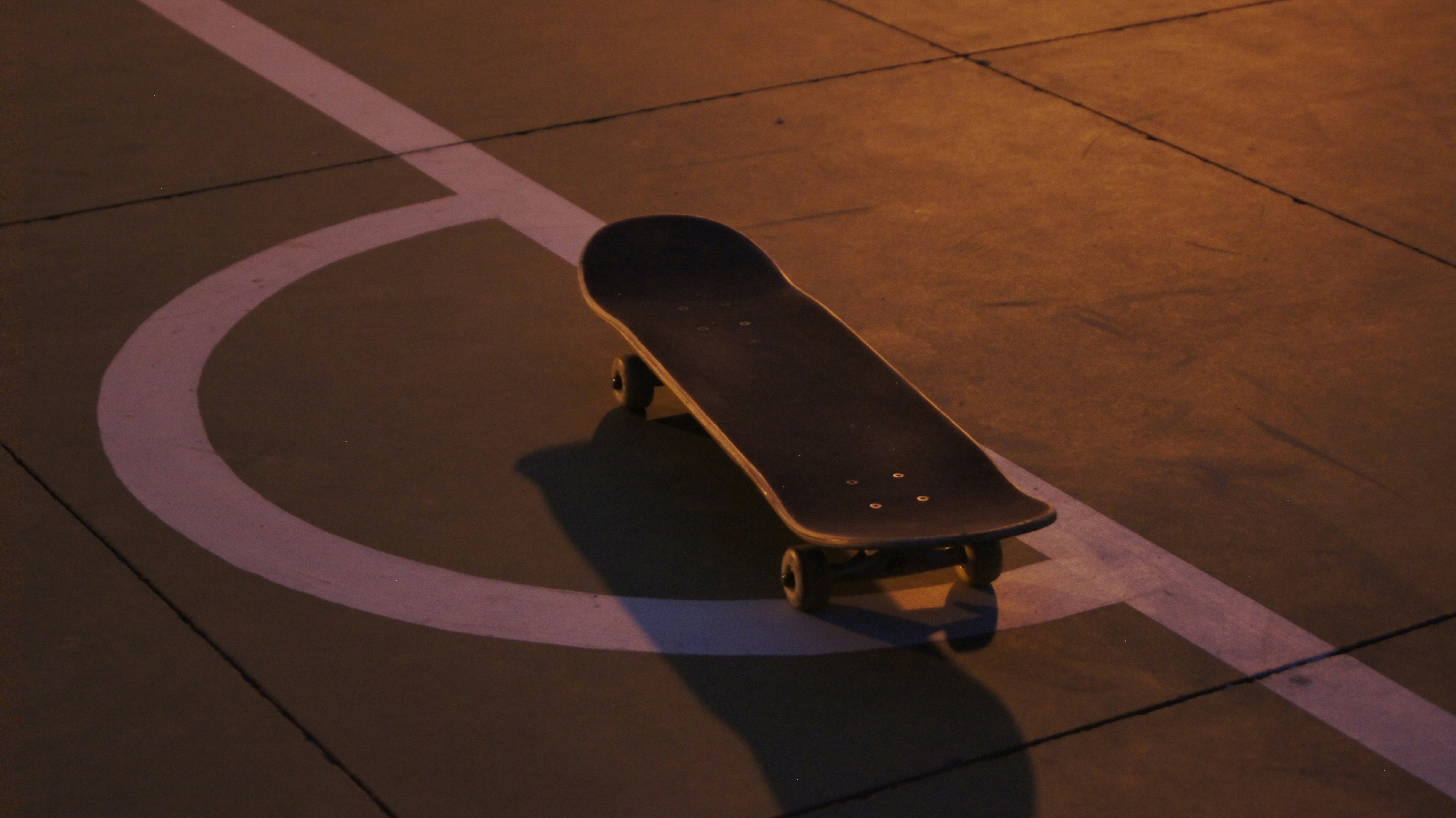 black skateboard on black concrete floor