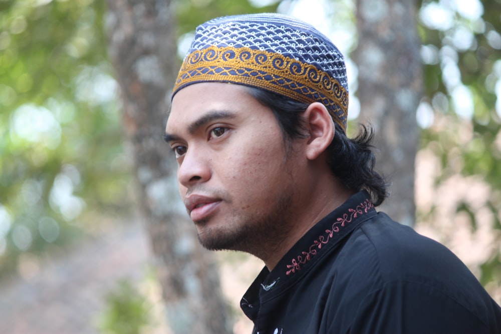 man in black shirt wearing blue and white bandana