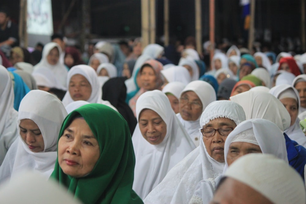 a large group of women in white headscarves