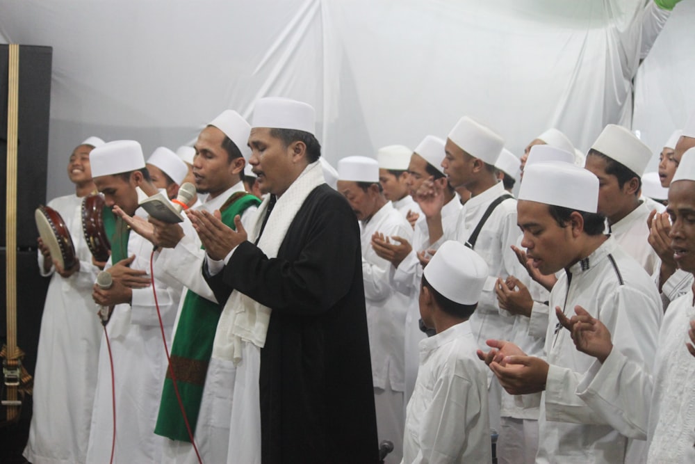 group of people wearing white thobe