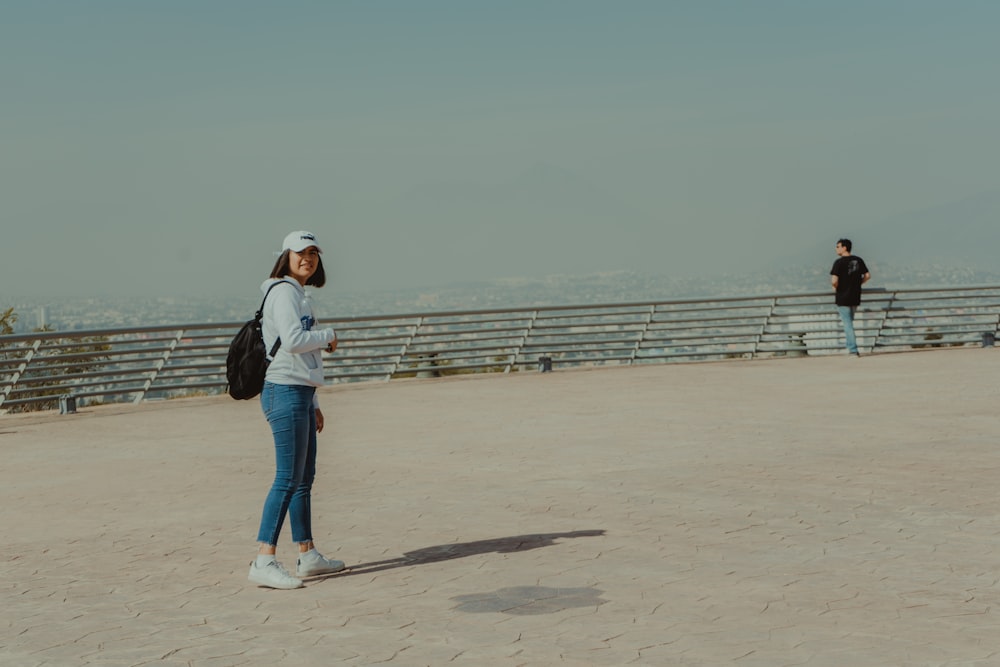 man and woman standing on sand during daytime