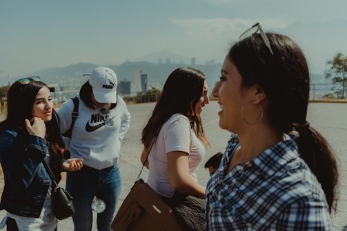 man in blue and white plaid button up shirt standing beside woman in white shirt during