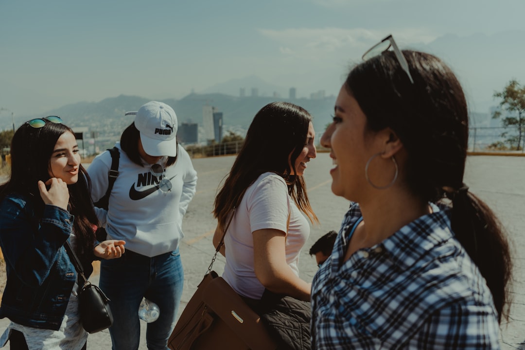 man in blue and white plaid button up shirt standing beside woman in white shirt during,