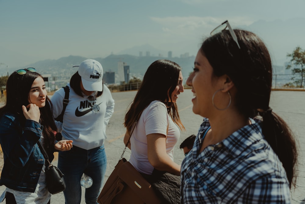 man in blue and white plaid button up shirt standing beside woman in white shirt during