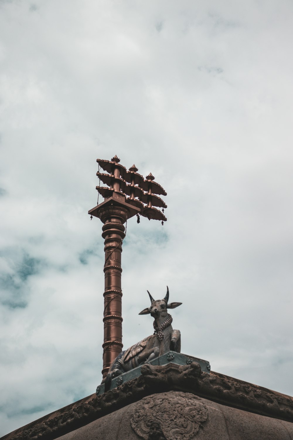 brown wooden cross under white clouds during daytime