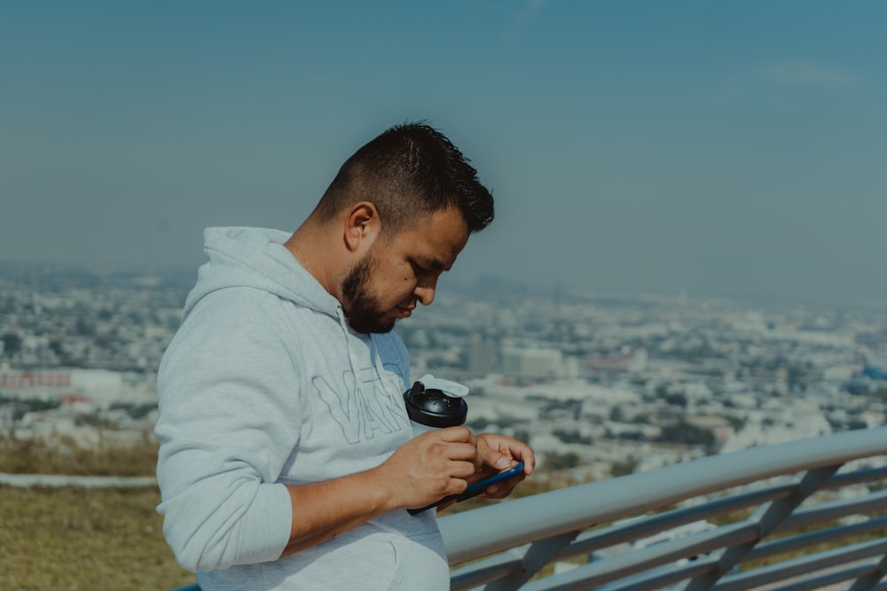 man in white dress shirt holding black dslr camera