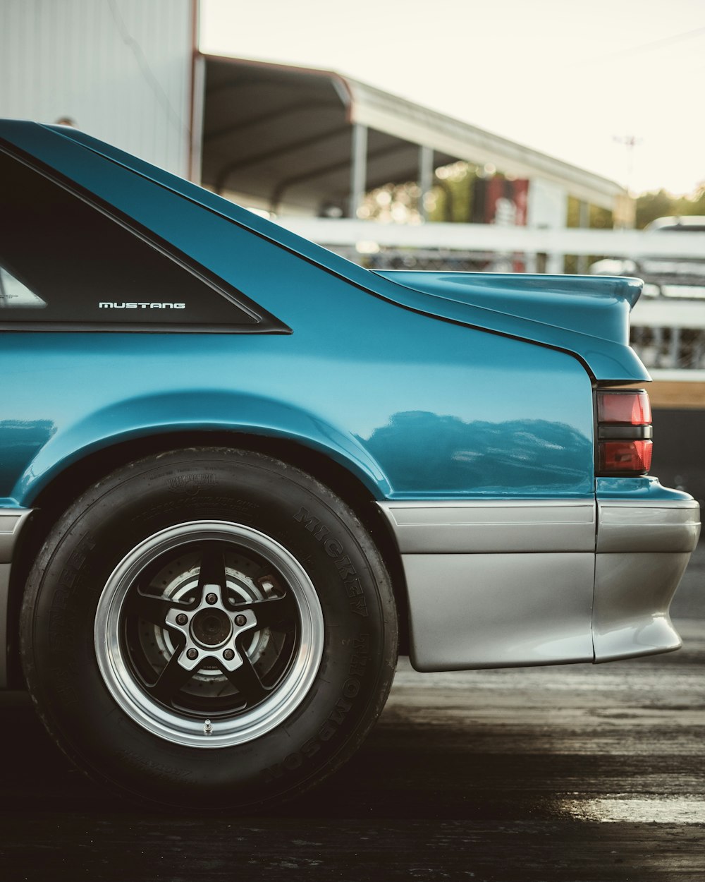 blue car on black asphalt road during daytime