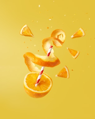 sliced orange fruit on yellow surface