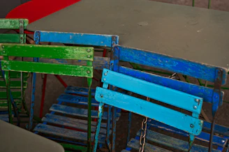 Washed cotton cloth chair covers neatly folded on a rustic wooden table, ready for easy use.