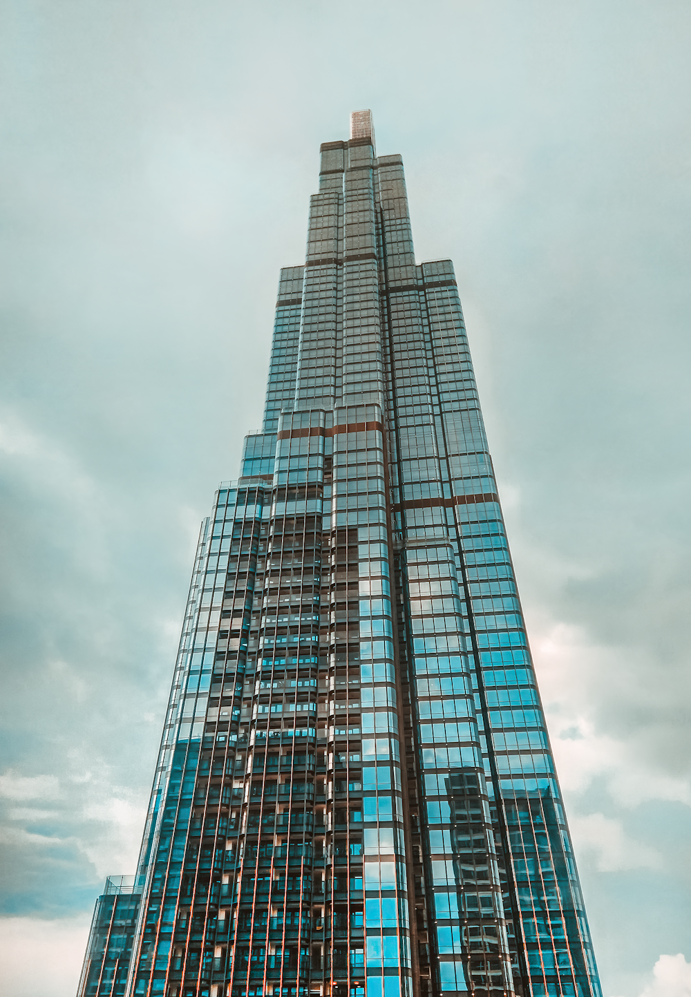 blue glass walled high rise building