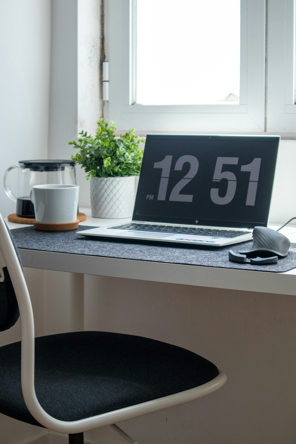 silver laptop computer on white table