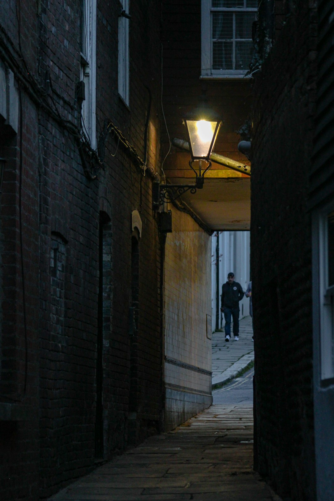 man in black jacket walking on hallway