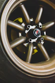 Close-up of a sleek, silver alloy wheel shining under natural light.