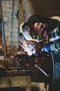 person in blue and white jacket holding white and black umbrella