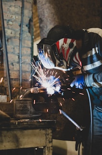 person in blue and white jacket holding white and black umbrella