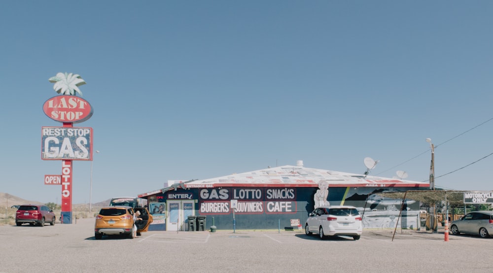 a gas station with cars parked in front of it