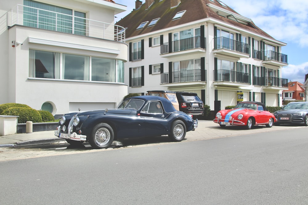 black coupe parked beside red car