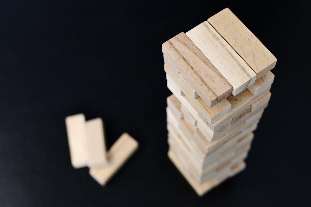 white wooden blocks on black surface