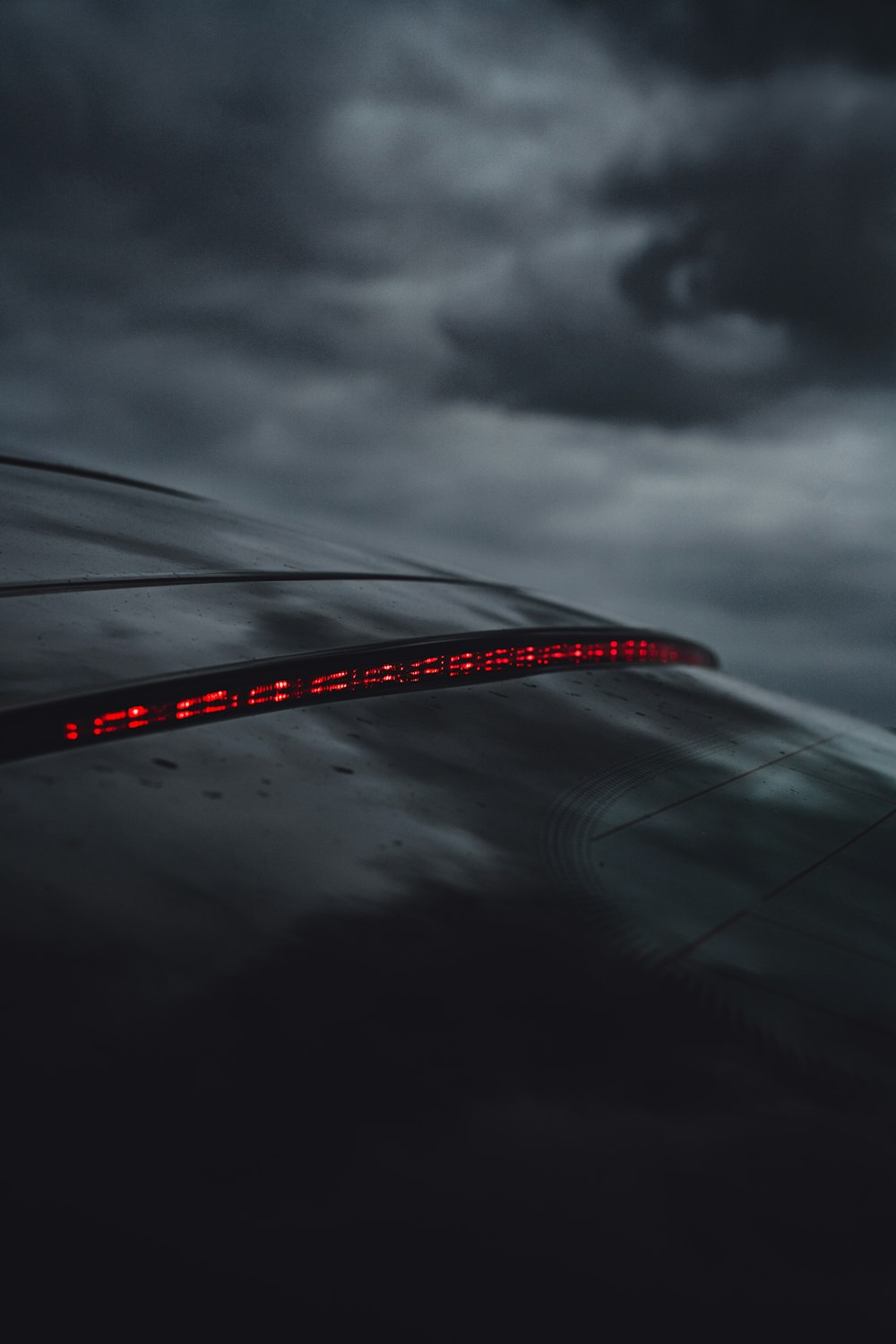 red and black bridge under gray clouds